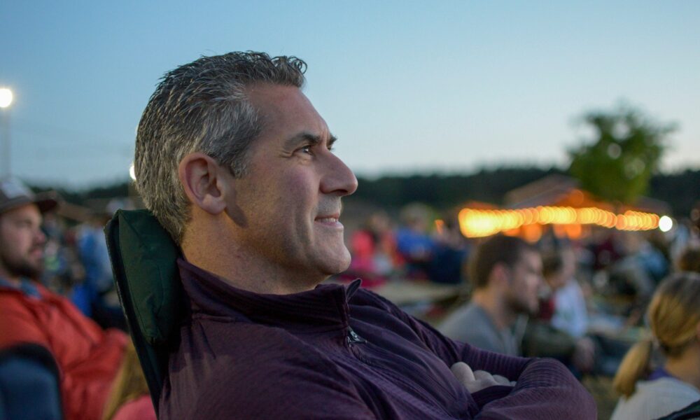 Man sitting outside at a festival