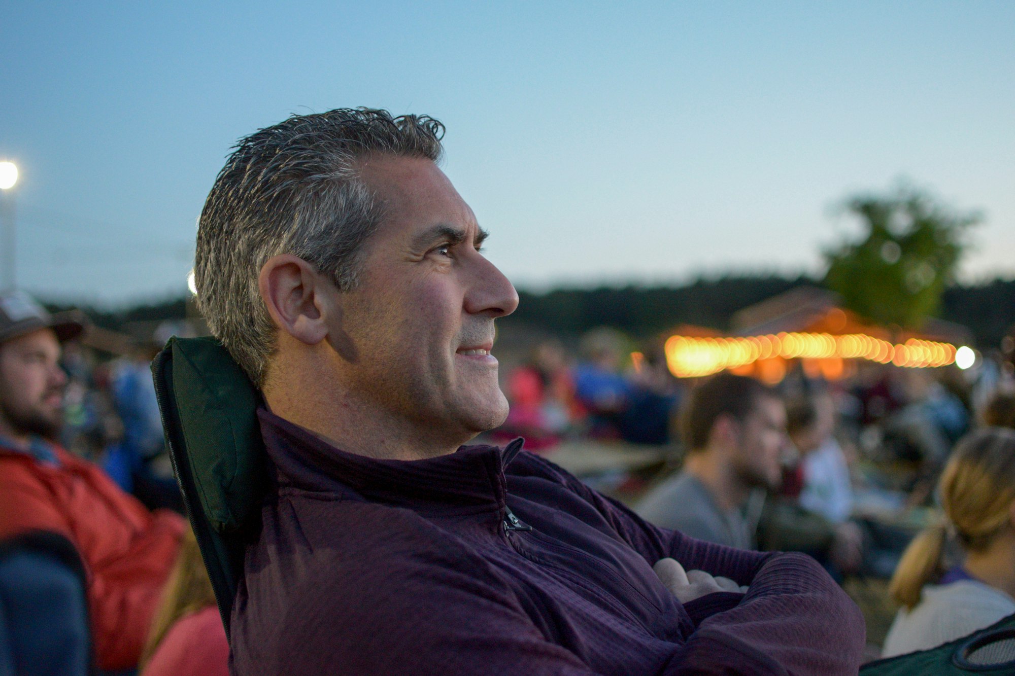 Man sitting outside at a festival